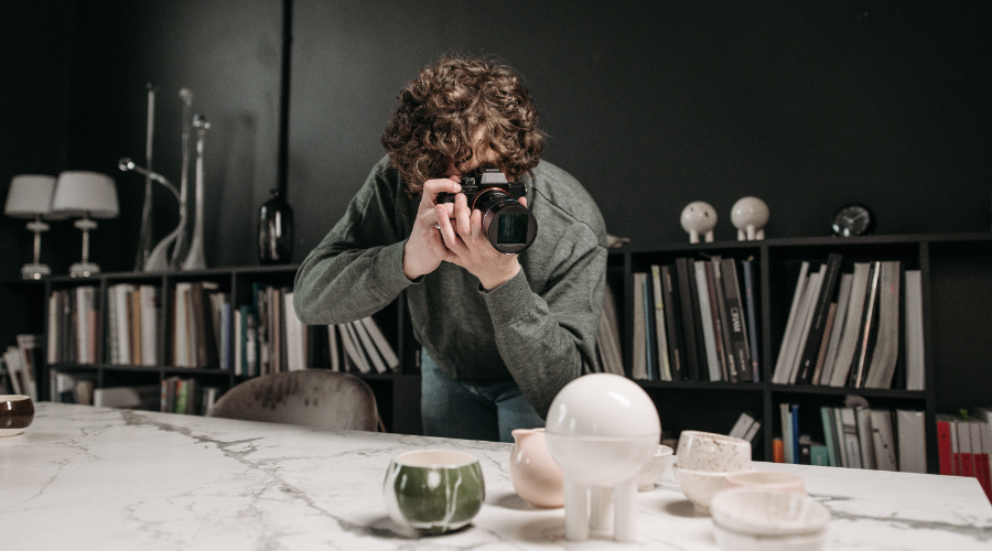 A man taking photos of his product to post on his website